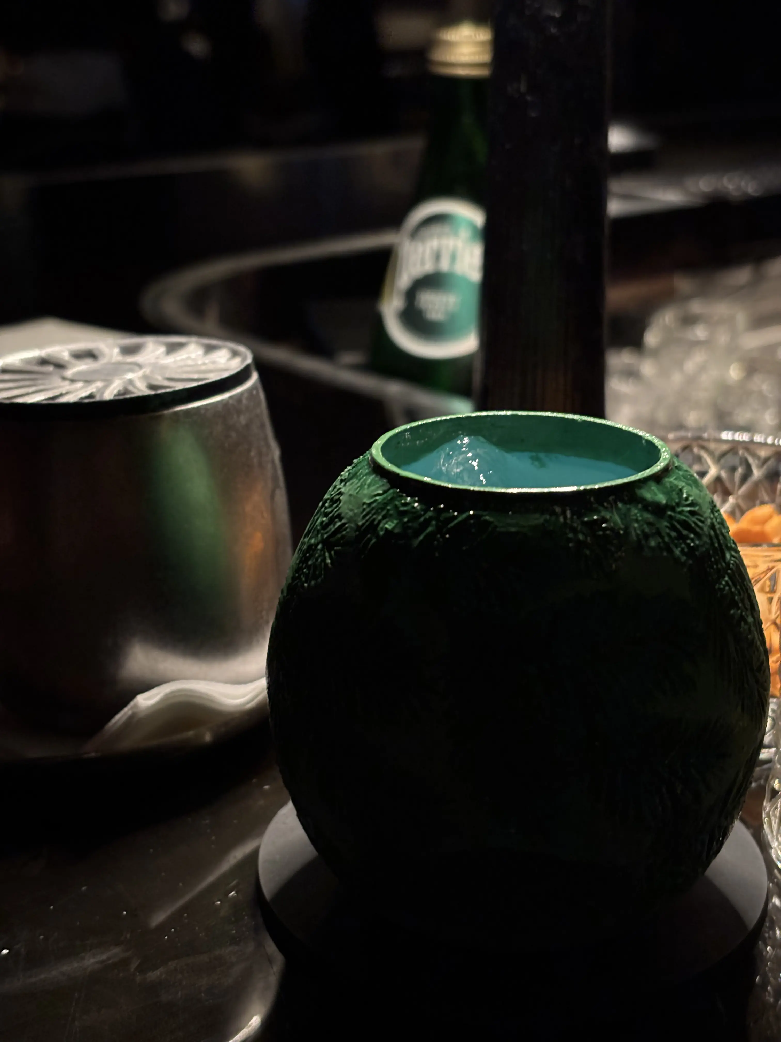A close-up of a bar counter taken at Darkside, Hong Kong, featuring two cups of Hong Kong-themed cocktails.